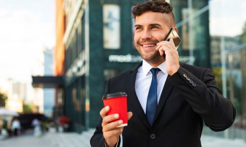 outdoors-business-man-drinking-his-coffee-talking-phone